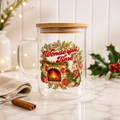 A clear glass mug with a bamboo lid, decorated with a festive Christmas illustration featuring a bunny, fireplace, holly, and the words 'It's the Most Wonderful Time.' This is the perfect compliment to your cozy evenings in!
